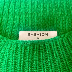 Green knit sweater top. Bold color with bold style including shoulder pads.